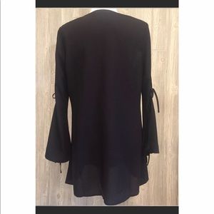 Black sheer top with details on the sleeves